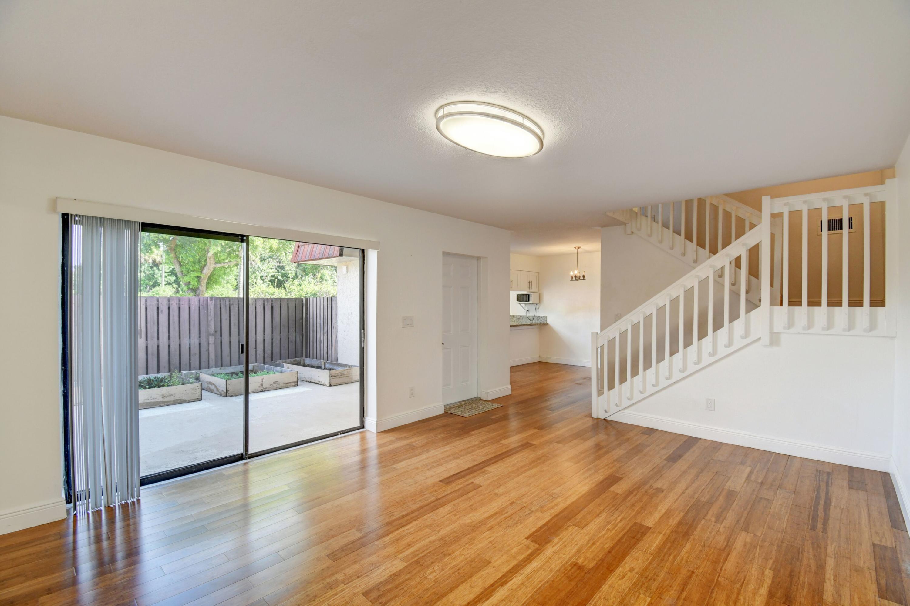 8253 Boca Rio Drive Boca Raton, FL 33433 - Photo 5 of 15 a view of an empty room with wooden floor and a window