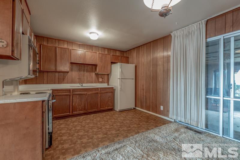 1275 Ebbetts Drive Reno, NV 89503 - Photo 8 of 8 a kitchen with a stove a refrigerator and a sink