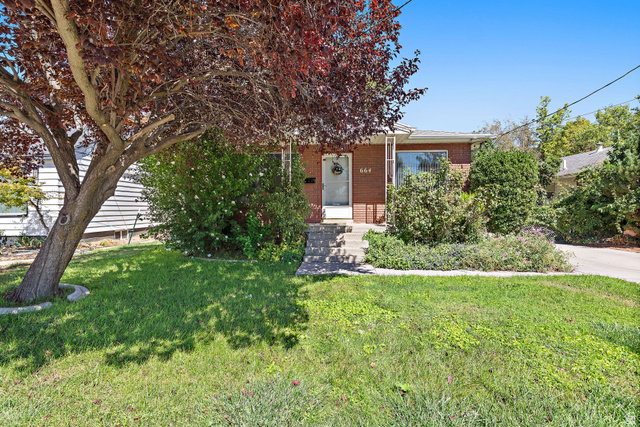 664 Wasatch Street Midvale, UT 84047 - Photo 1 of 33 Brick exterior with a covered entry, mature landscaping, and a concrete driveway