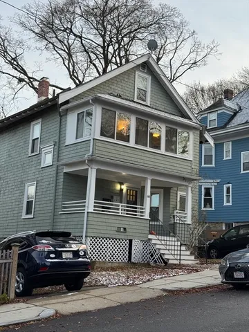 a front view of a house with parking space