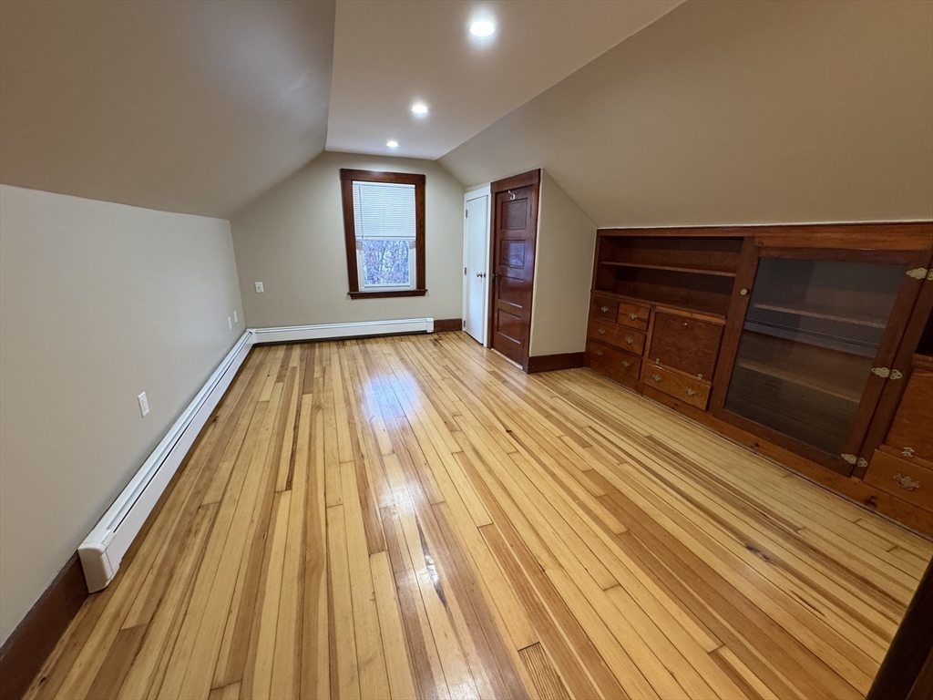 68 Aldrich Street, Unit 2 Boston, MA 02131 - Photo 10 of 12 a view of an empty room with wooden floor and a window