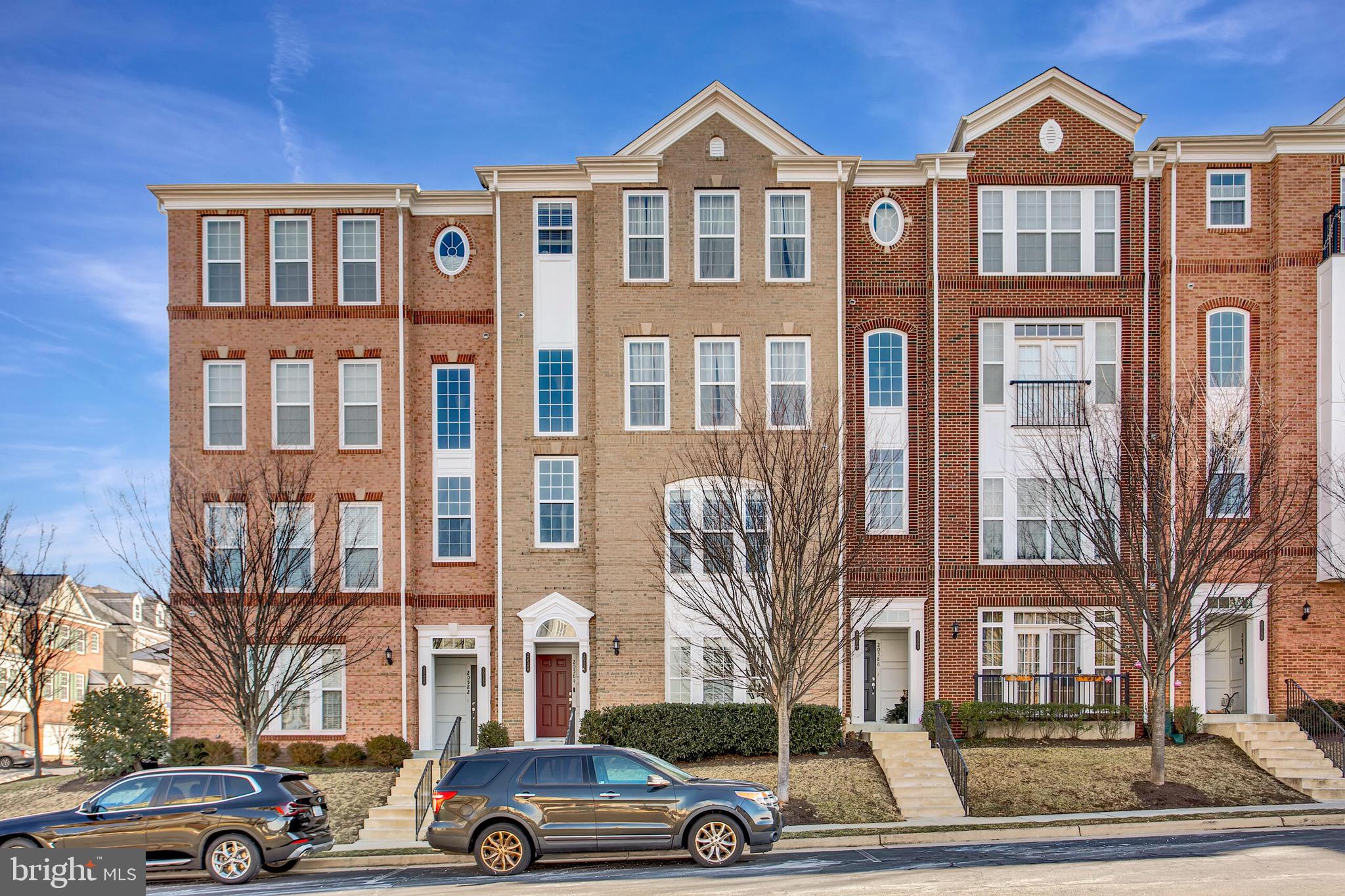 a front view of a residential apartment building with a yard