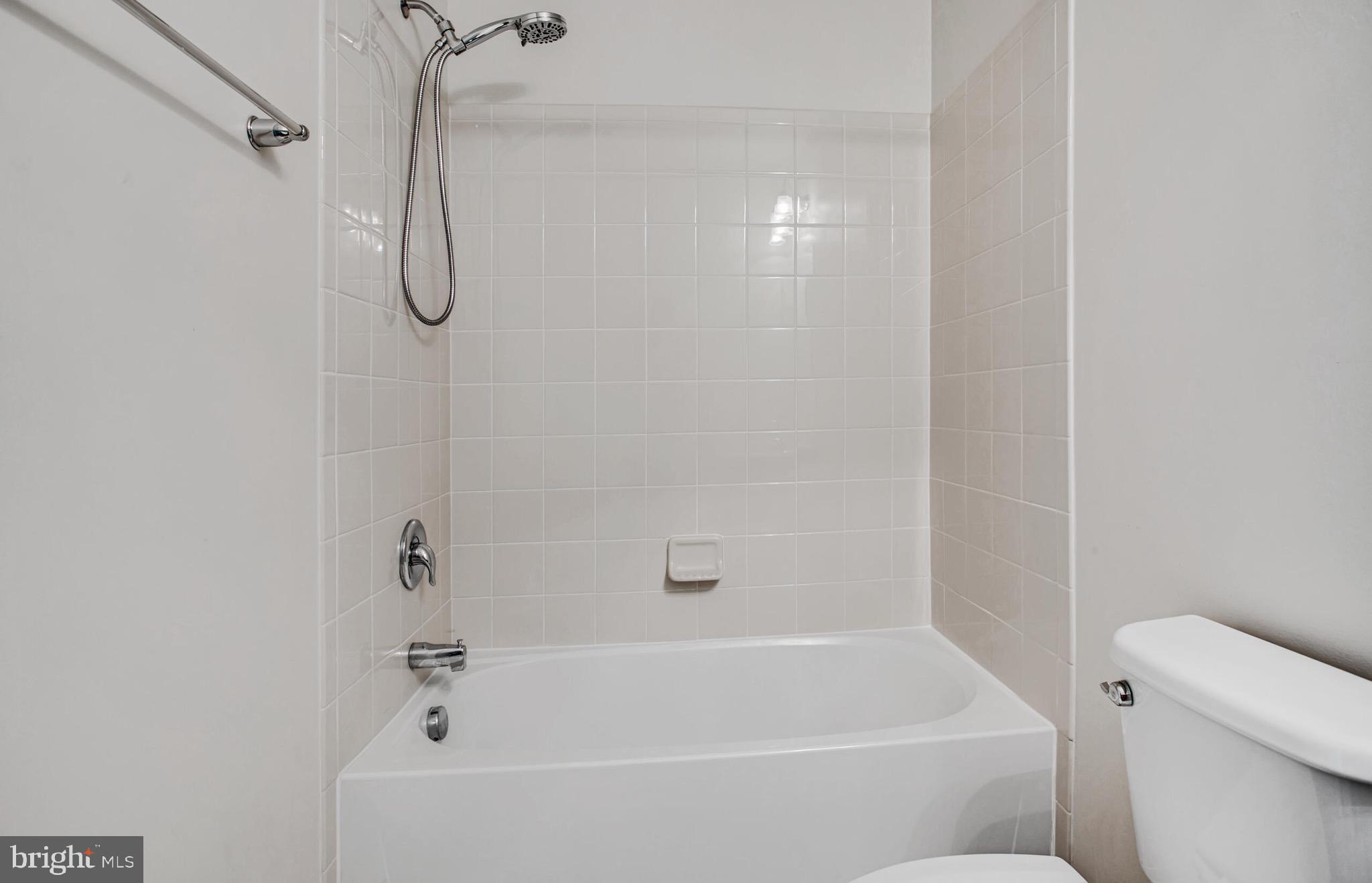 20586 Maitland Terrace Ashburn, VA 20147 - Photo 16 of 24 a bathroom with a bath tub with a shower