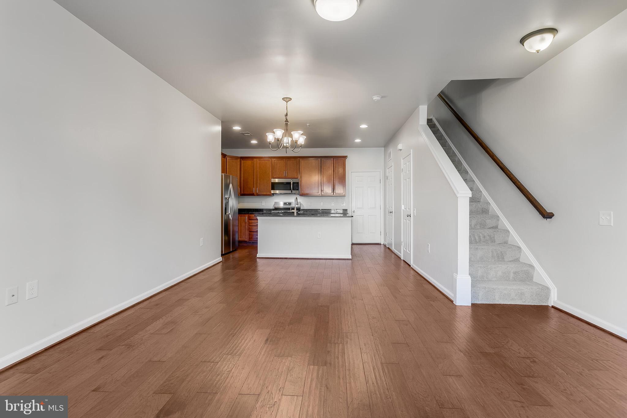 20586 Maitland Terrace Ashburn, VA 20147 - Photo 24 of 24 a view of a kitchen with a sink and microwave with wooden floor