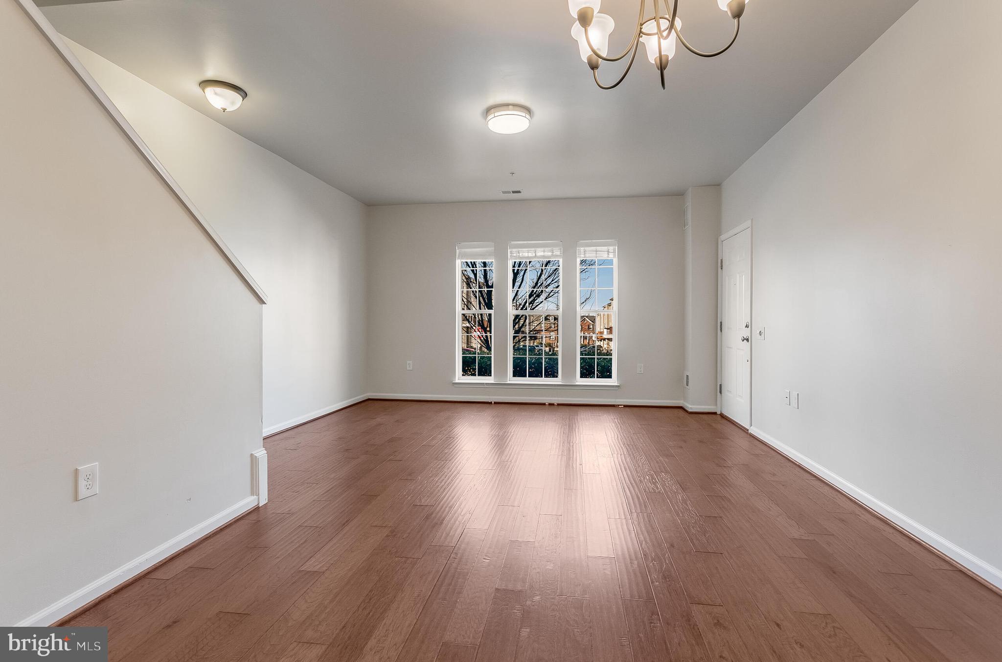 20586 Maitland Terrace Ashburn, VA 20147 - Photo 6 of 24 a view of an empty room with wooden floor and a window