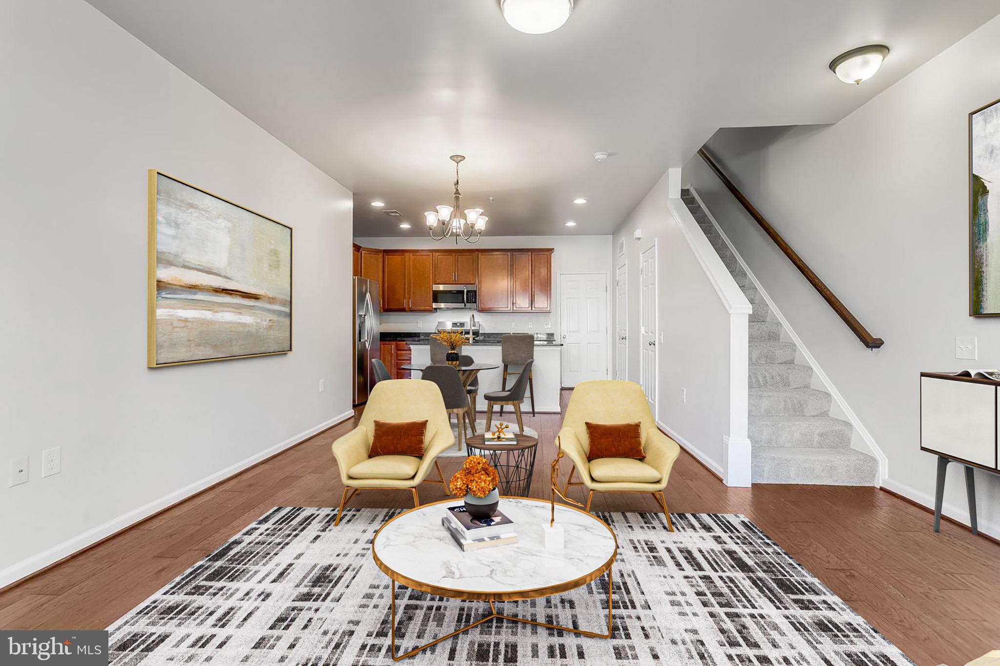 20586 Maitland Terrace Ashburn, VA 20147 - Photo 8 of 24 a living room with dining table and wooden floor
