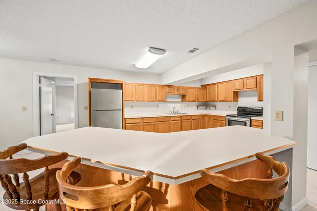a view of a kitchen with a table and chairs
