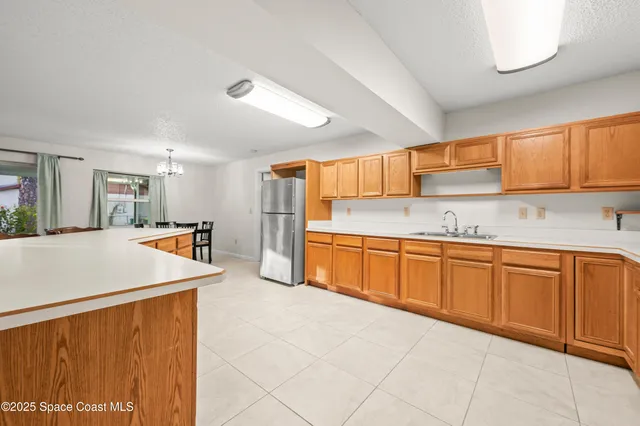 a kitchen with stainless steel appliances granite countertop a refrigerator sink and cabinets