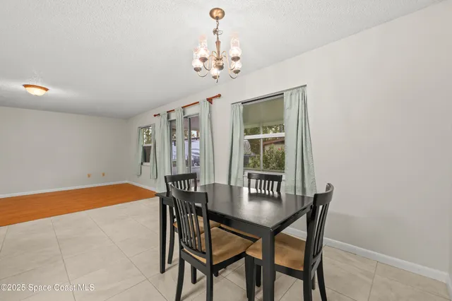 an empty room with fan and windows