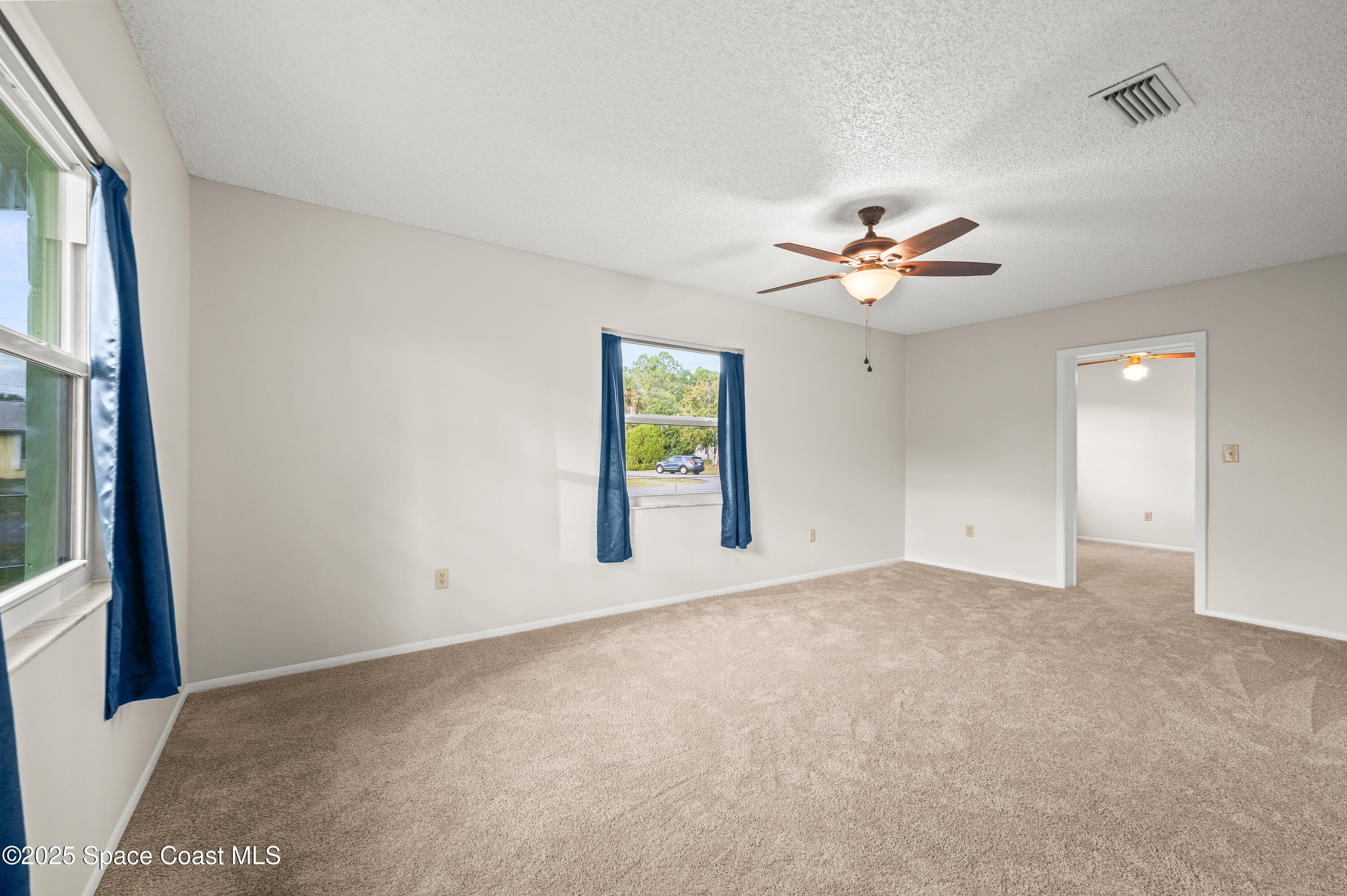 6450 Ember Avenue Cocoa, FL 32927 - Photo 16 of 40 an empty room with fan and windows