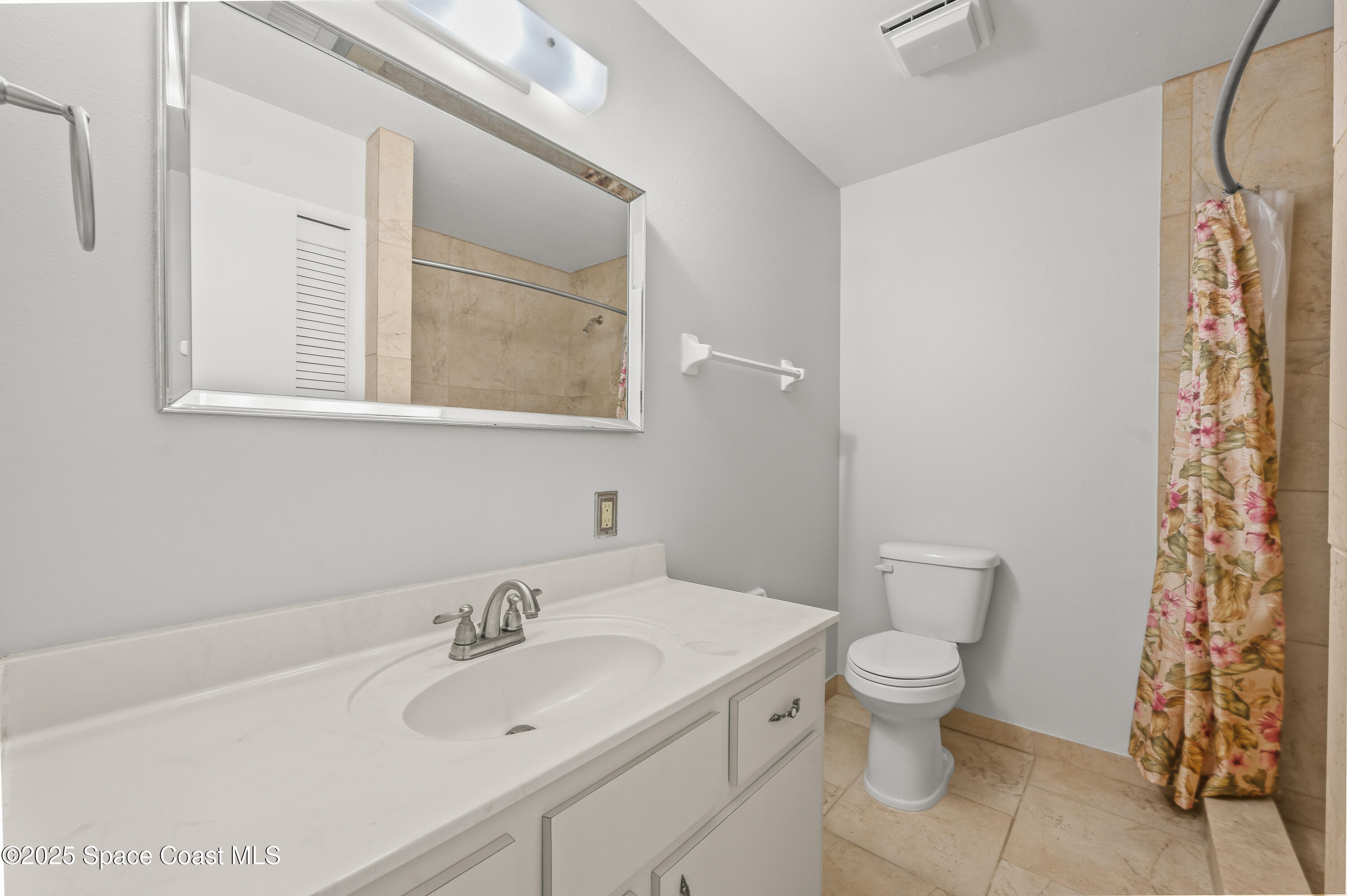 6450 Ember Avenue Cocoa, FL 32927 - Photo 18 of 40 a bathroom with a white sink a toilet and a shower