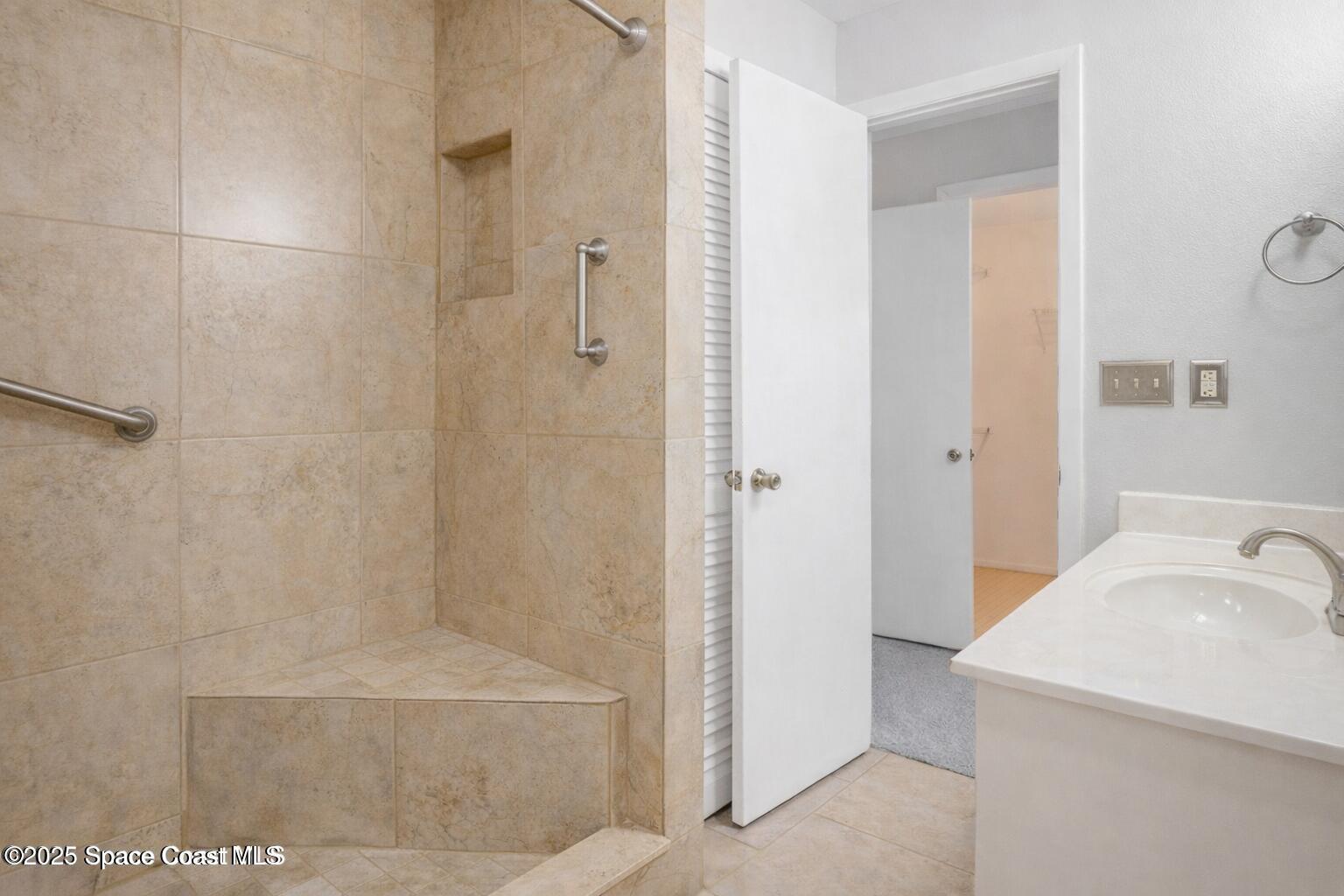 6450 Ember Avenue Cocoa, FL 32927 - Photo 19 of 40 a bathroom with a sink and a shower