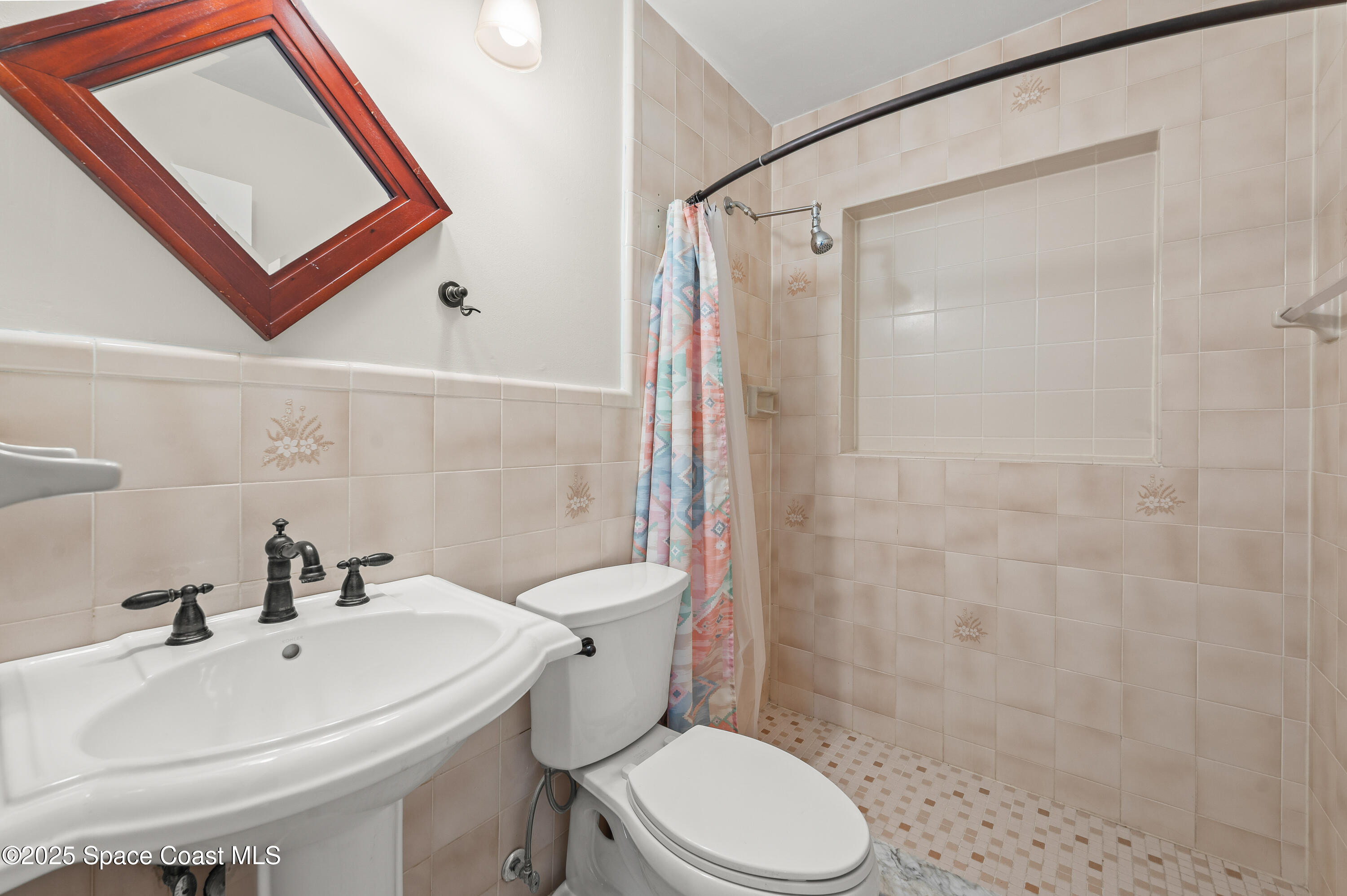 6450 Ember Avenue Cocoa, FL 32927 - Photo 26 of 40 a white toilet sitting next to a bathroom sink