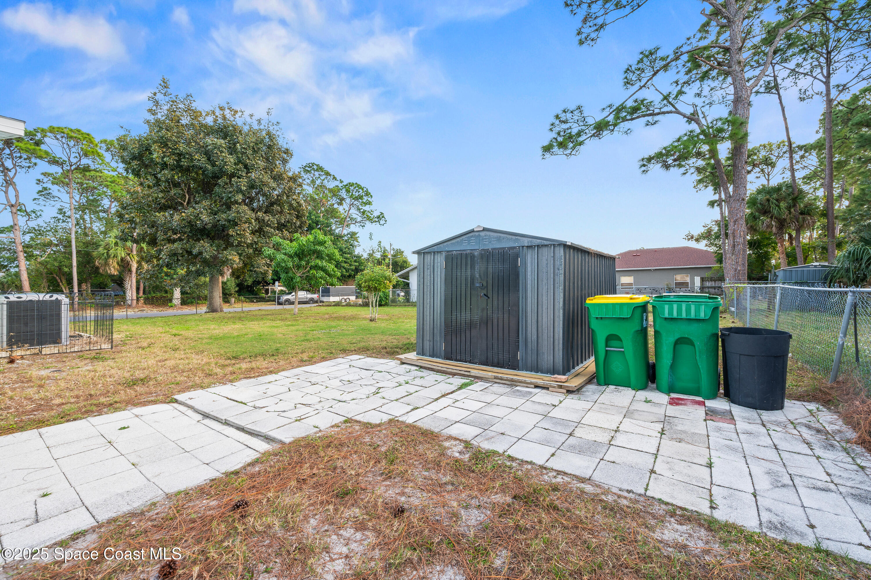 6450 Ember Avenue Cocoa, FL 32927 - Photo 34 of 40 a view of a backyard with large trees