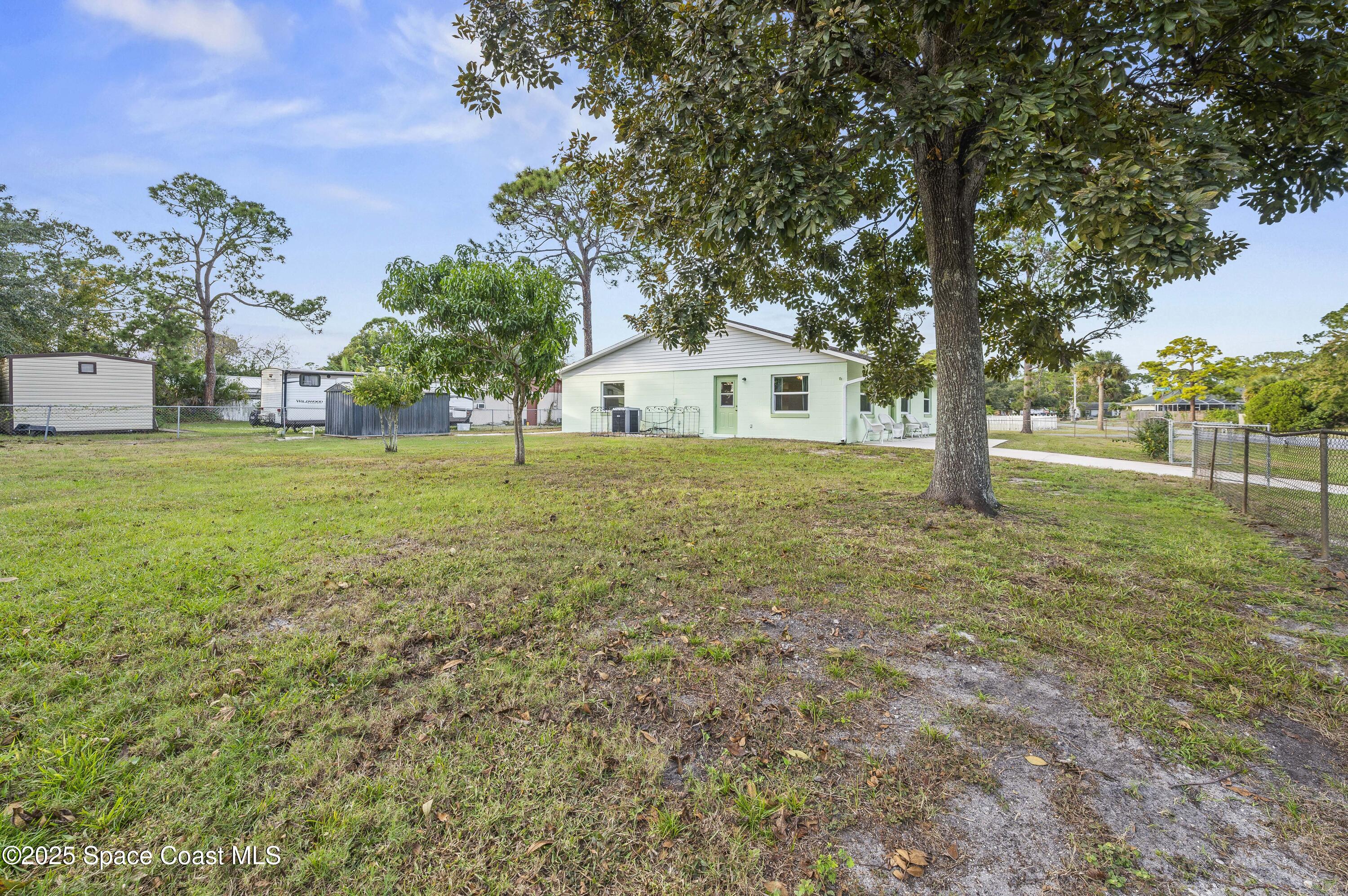 6450 Ember Avenue Cocoa, FL 32927 - Photo 36 of 40 a big house with trees in front of it