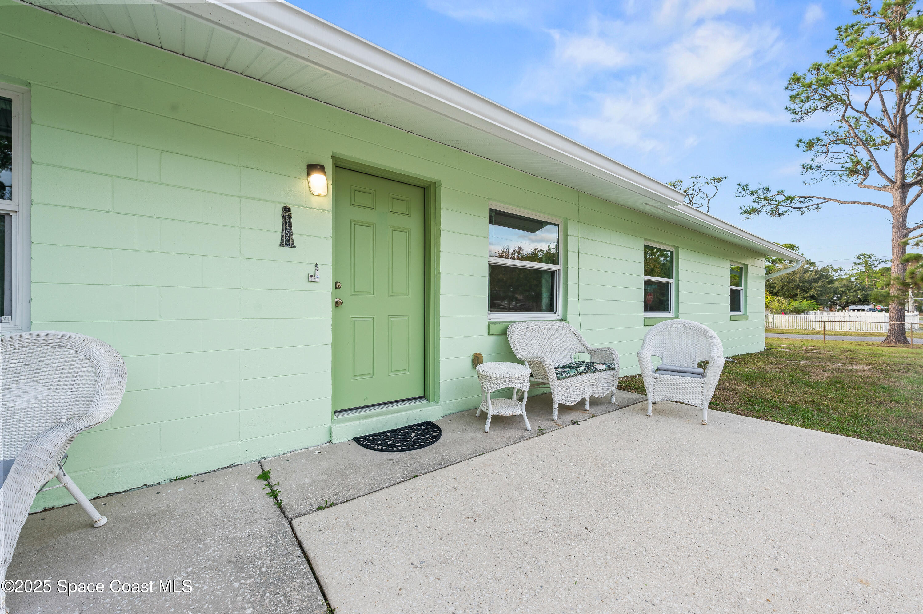 6450 Ember Avenue Cocoa, FL 32927 - Photo 4 of 40 a patio with table and chairs and garden
