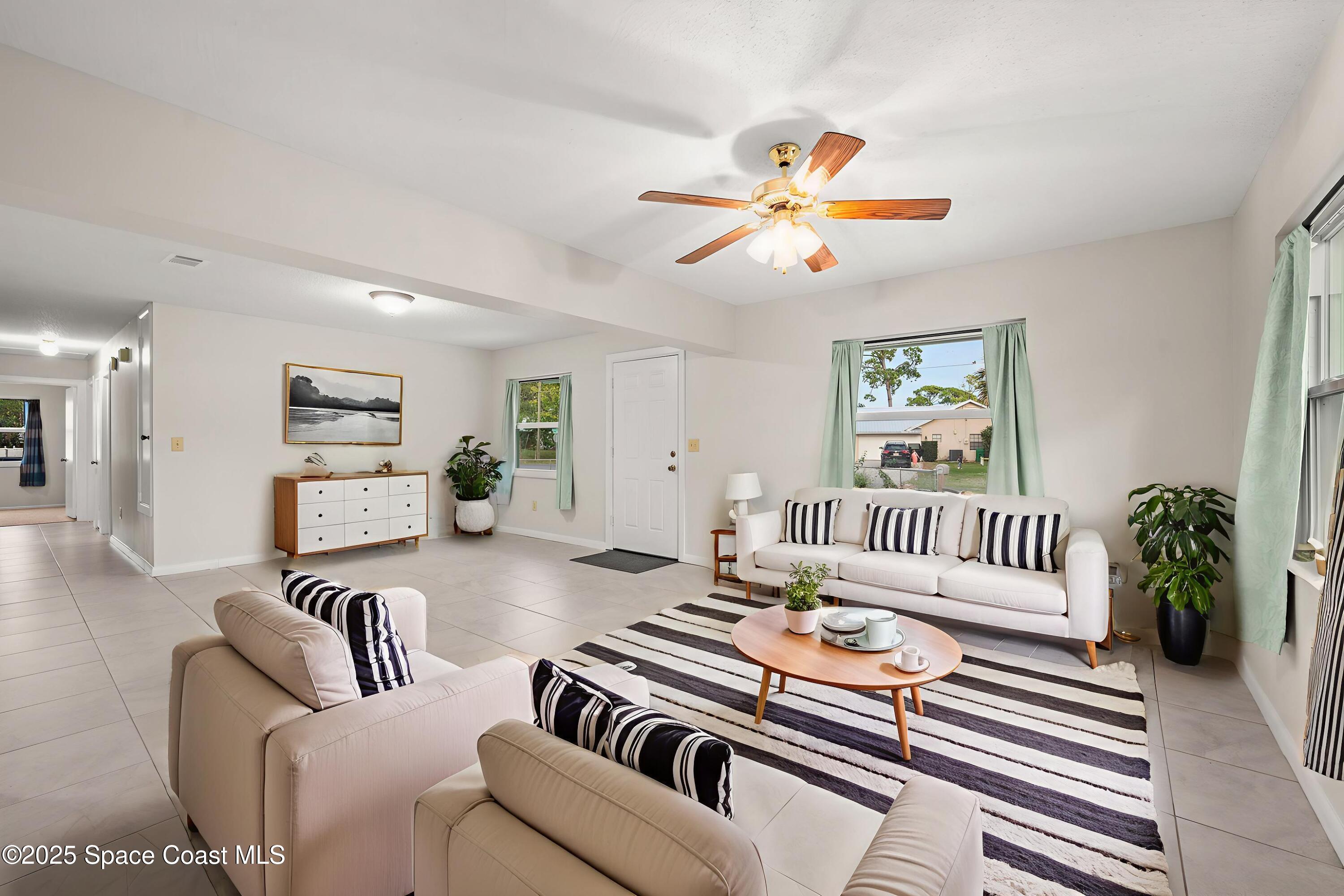 6450 Ember Avenue Cocoa, FL 32927 - Photo 7 of 40 a living room with furniture and a rug