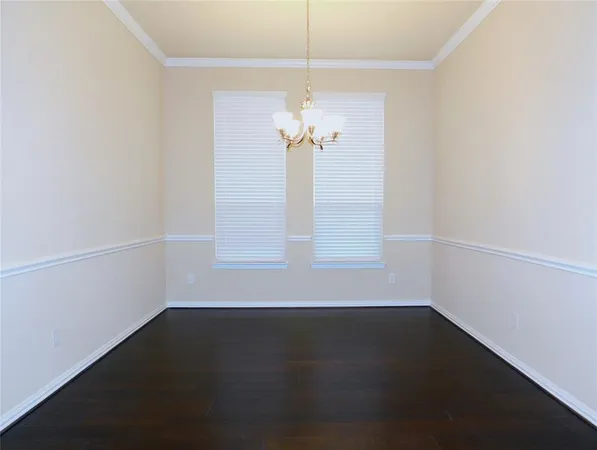 a view of a room with wooden floor and a ceiling fan
