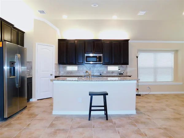 a kitchen with stainless steel appliances granite countertop a refrigerator sink and cabinets