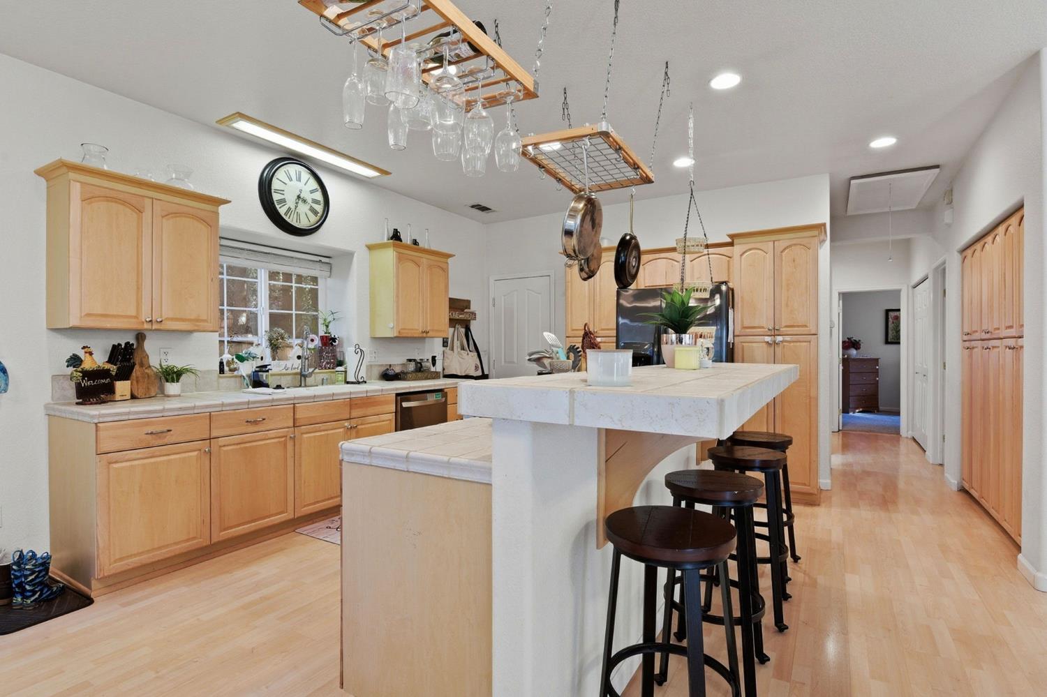 2845 Viona Road Pollock Pines, CA 95726 - Photo 13 of 35 a kitchen with stainless steel appliances a stove a refrigerator a sink dishwasher with a dining table and chairs