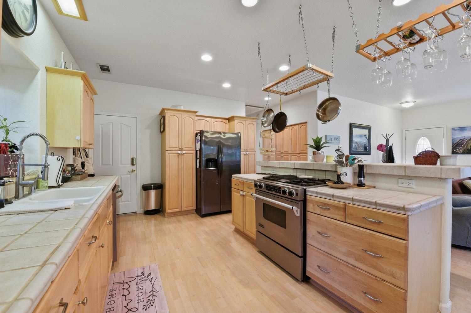 2845 Viona Road Pollock Pines, CA 95726 - Photo 14 of 32 a large kitchen with stainless steel appliances granite countertop a lot of counter space and wooden floors