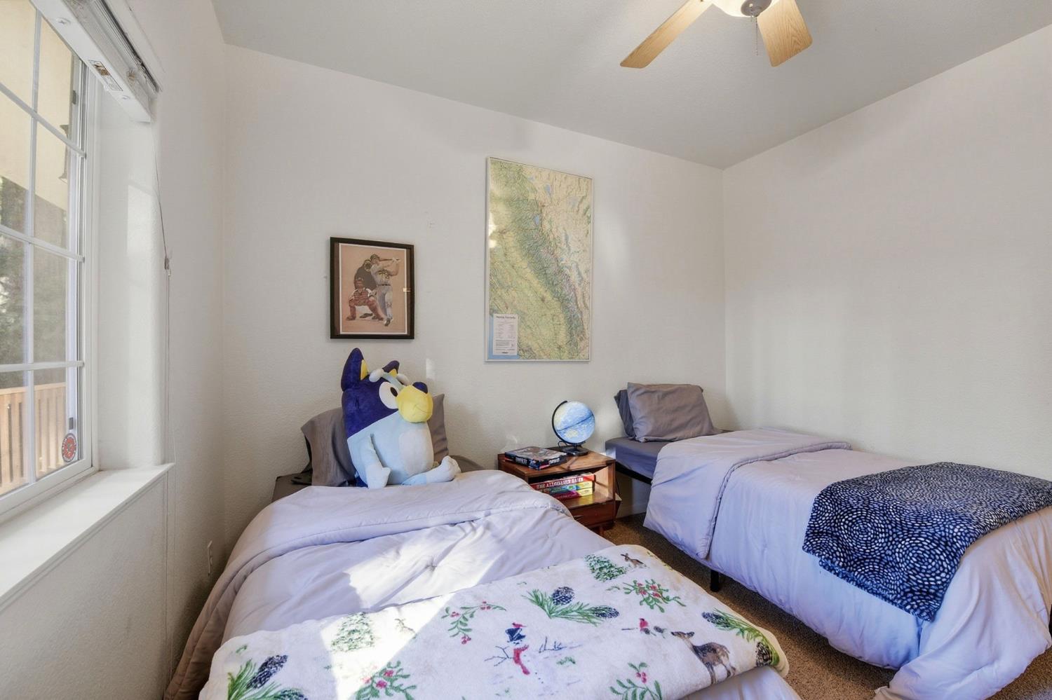 2845 Viona Road Pollock Pines, CA 95726 - Photo 20 of 32 a bedroom with two beds and a painting on the wall