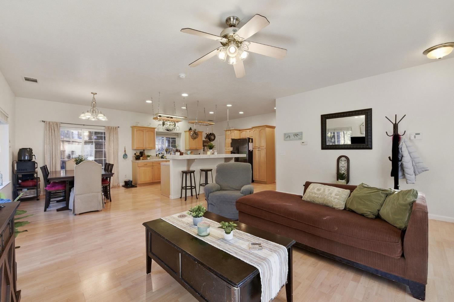2845 Viona Road Pollock Pines, CA 95726 - Photo 9 of 35 a living room with furniture kitchen view and a chandelier