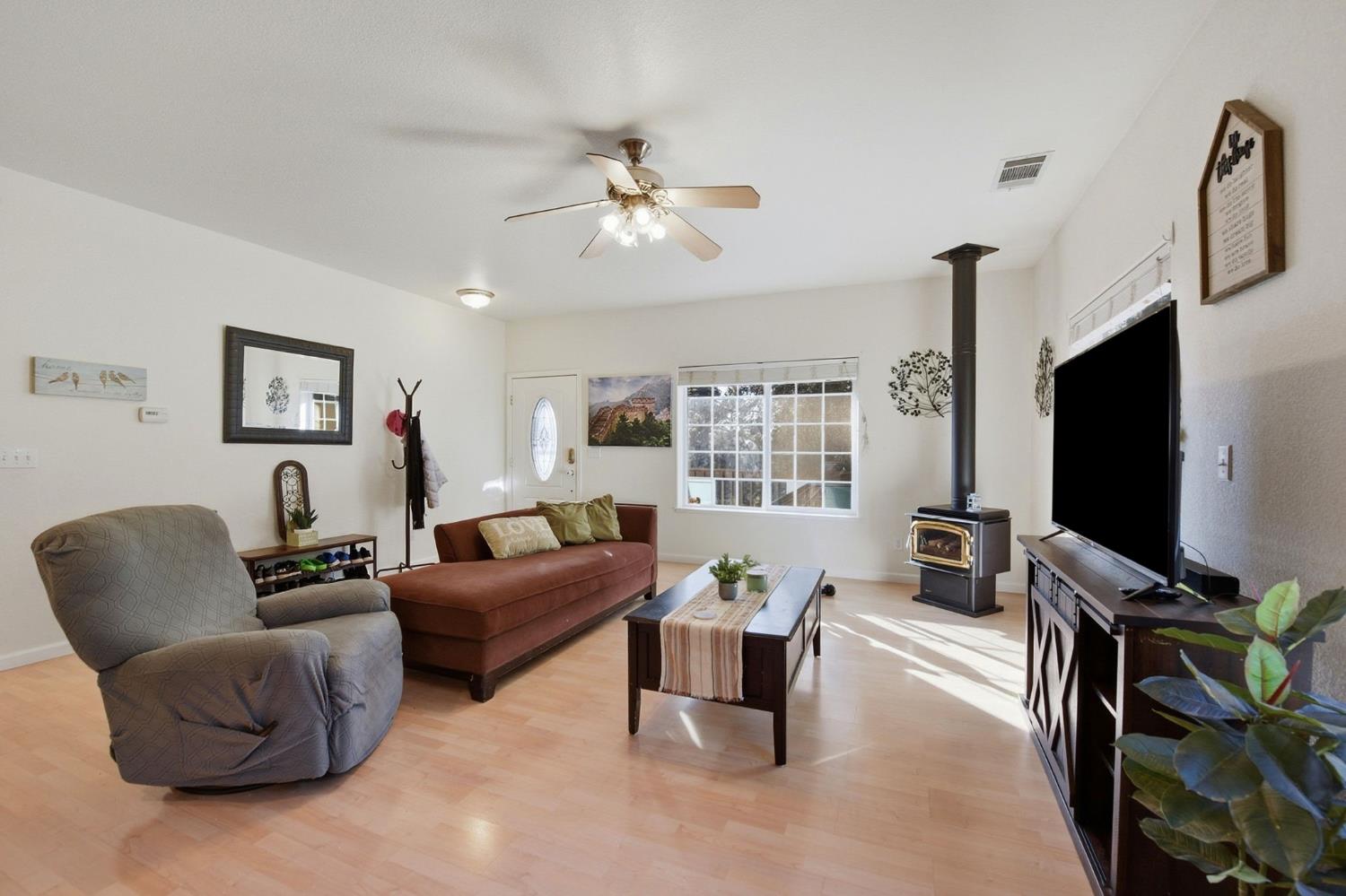 2845 Viona Road Pollock Pines, CA 95726 - Photo 10 of 35 a living room with furniture a ceiling fan and a flat screen tv