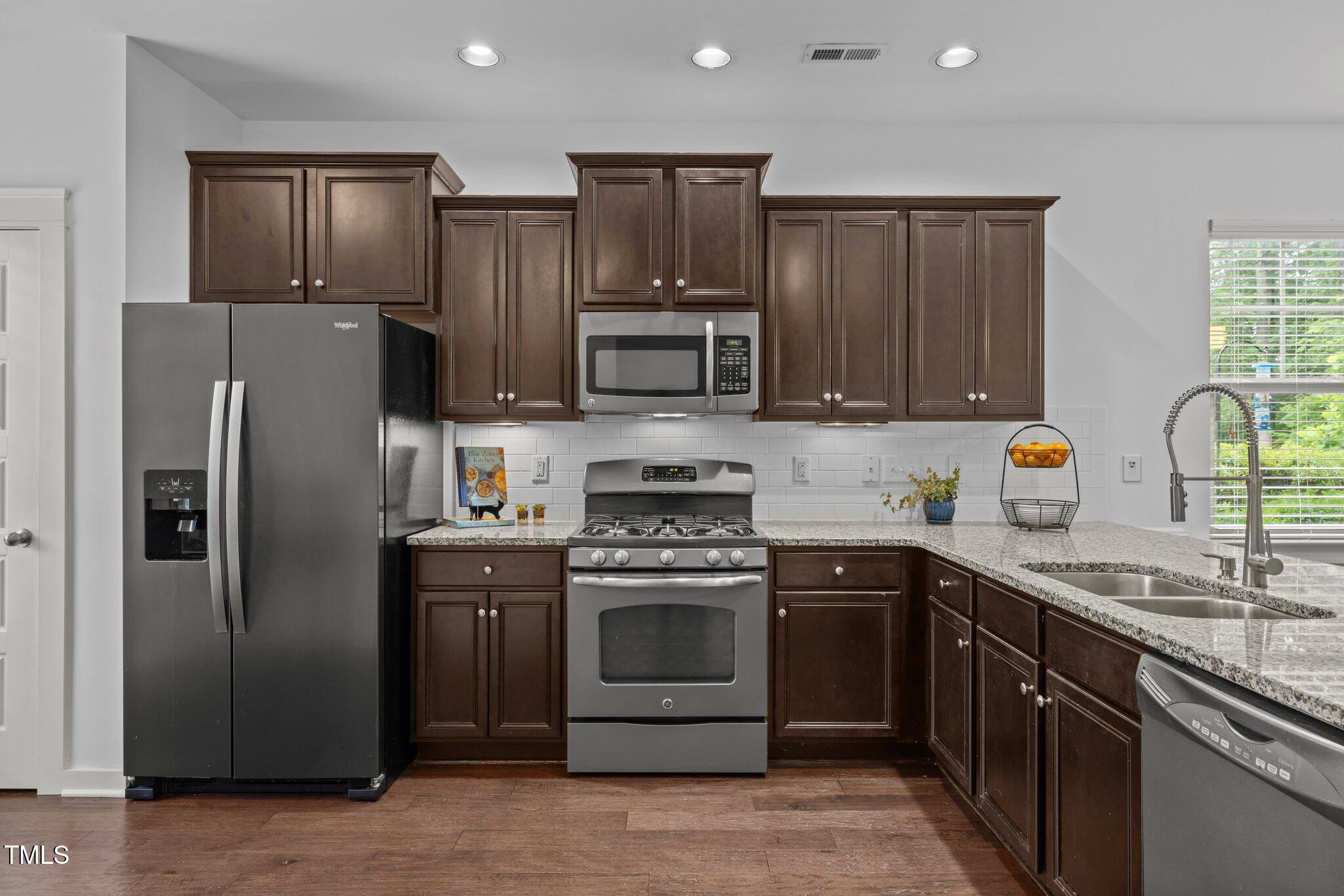 7871 Allscott Way Raleigh, NC 27612 - Photo 10 of 32 Kitchen features stainless steel appliances, recessed lighting, pantry & island for meal prep.