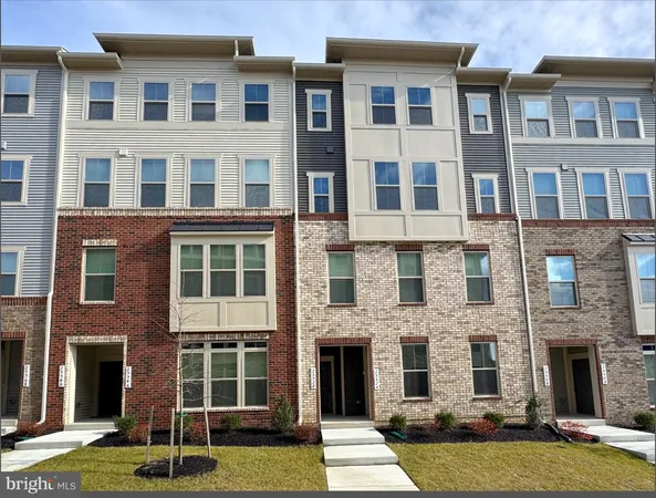 a front view of a building with a yard