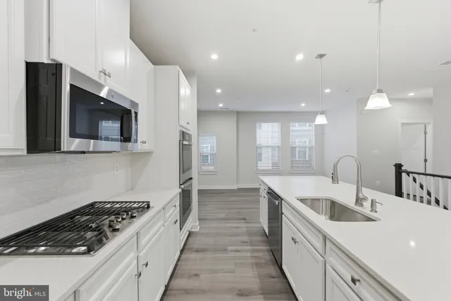 a kitchen with a sink and stainless steel appliances
