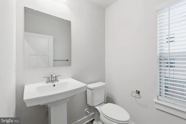 a bathroom with a sink toilet and vanity