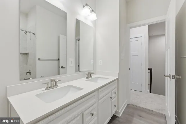 a bathroom with double vanity sink and a mirror