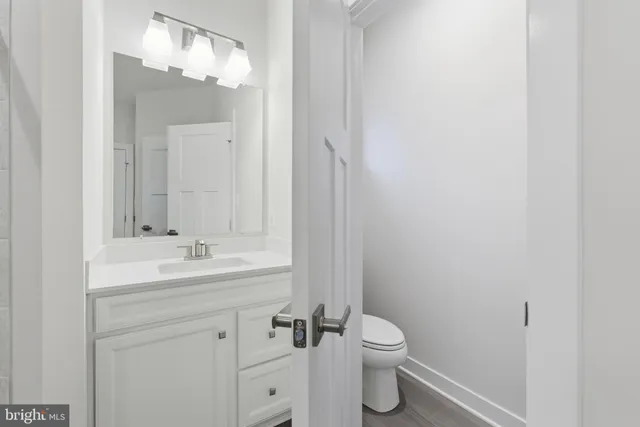 a bathroom with a toilet a sink and mirror