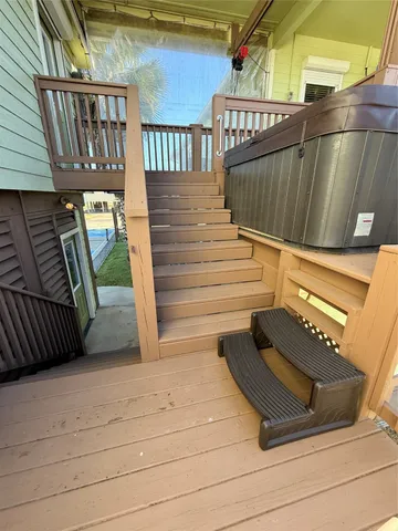 a view of a swimming pool with a table and chairs in the porch