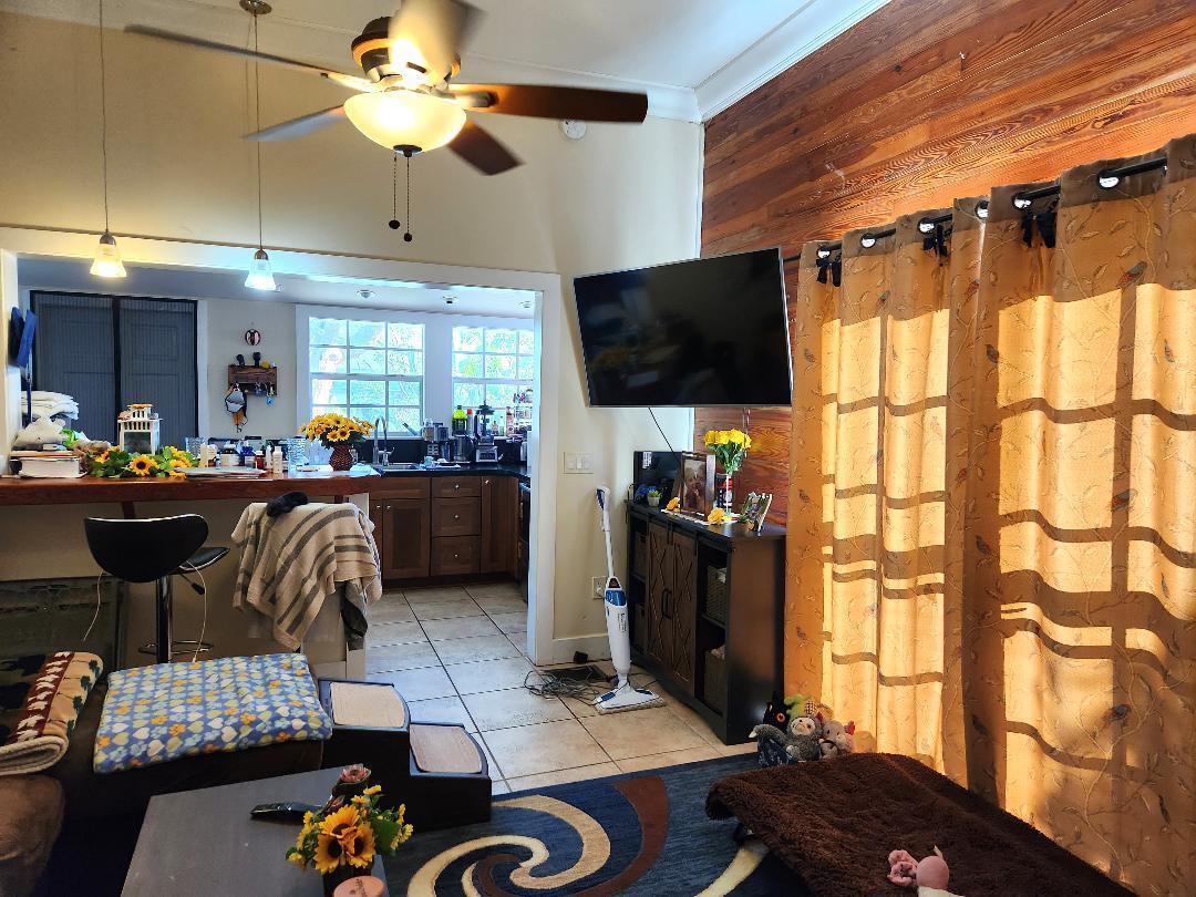 2210 Staples Avenue Key West, FL 33040 - Photo 21 of 33 a living room with furniture a flat screen tv and a window