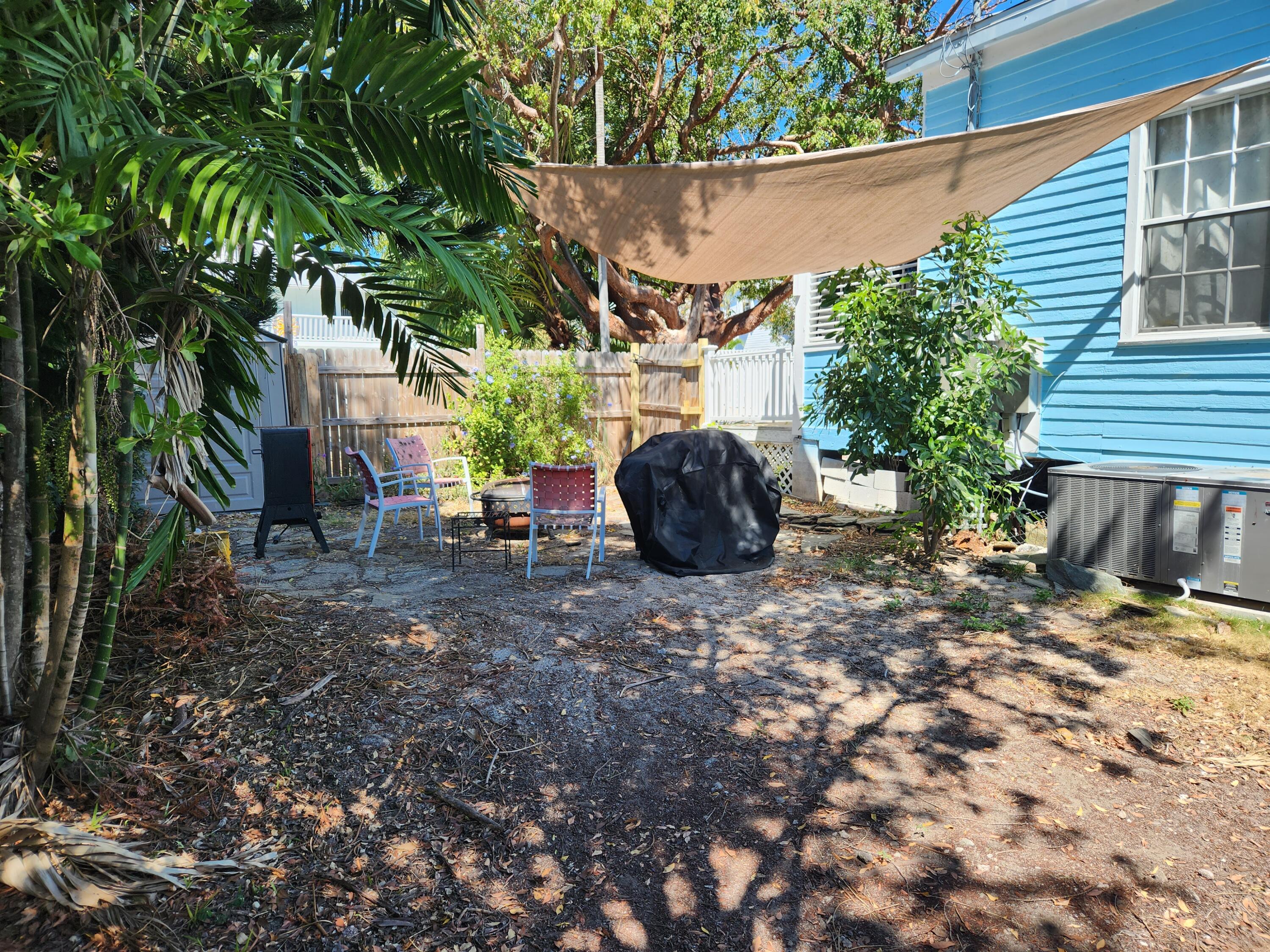 2210 Staples Avenue Key West, FL 33040 - Photo 4 of 33 a view of a chairs and table in the backyard