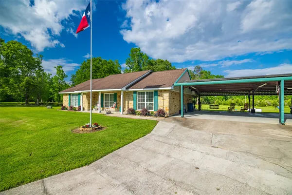 a front view of house with yard and green space