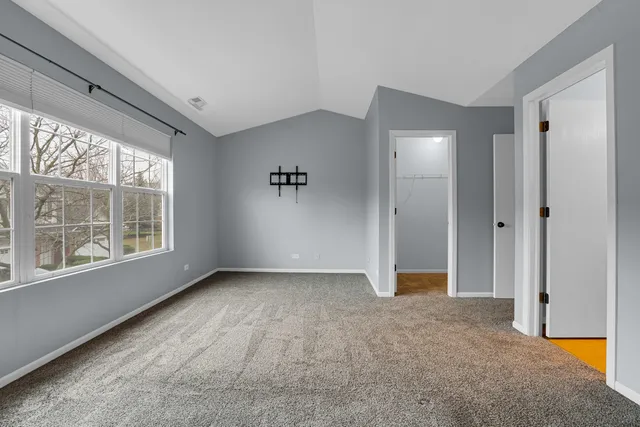 an empty room with windows and closet