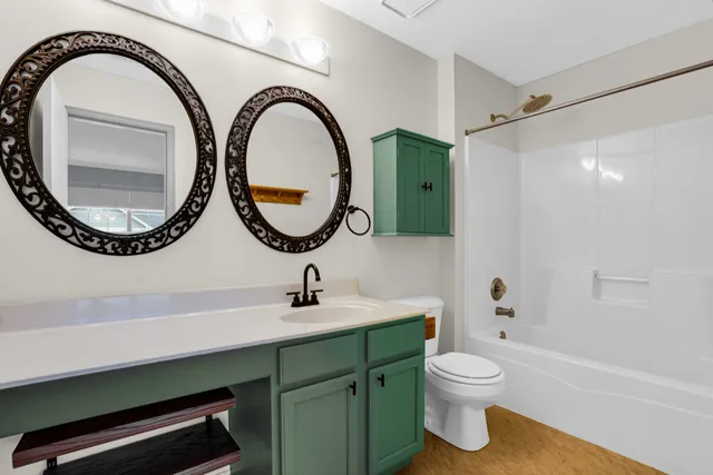 a bathroom with a toilet a sink and a mirror