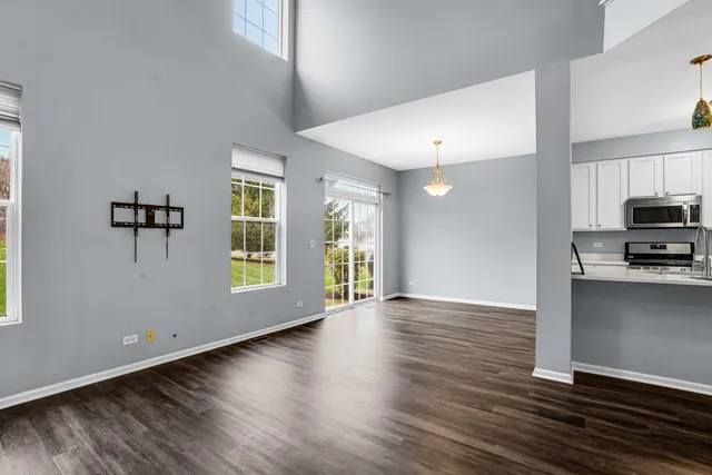 a view of wooden floor and windows in a room