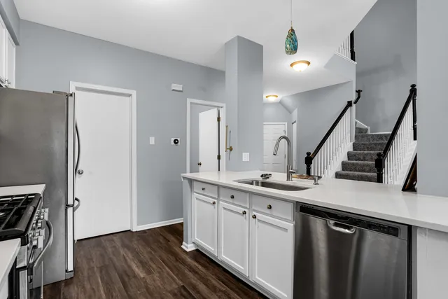 a kitchen with a sink appliances and cabinets