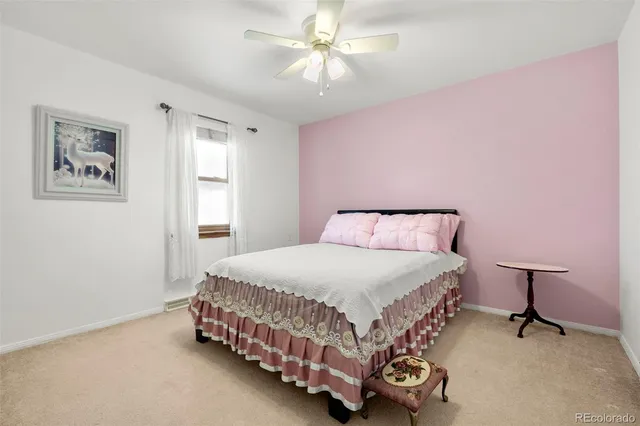 a bedroom with a bed and a lamp