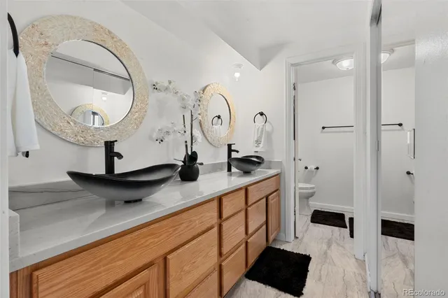a bathroom with a double vanity sink and a mirror