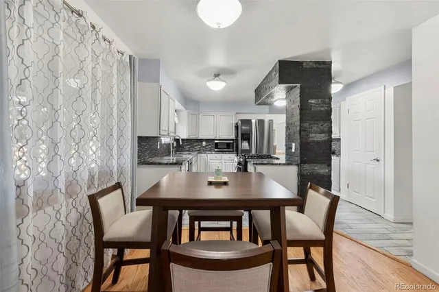 a view of a dining room with furniture and wooden floor