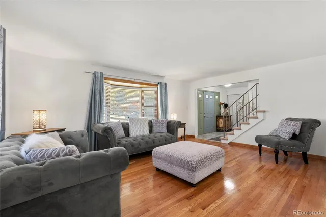 a bedroom with furniture and a wooden floor