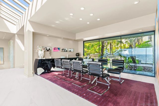 a living room with furniture and large windows