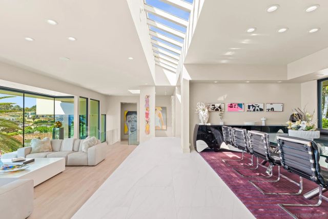 a kitchen with sink a microwave and cabinets