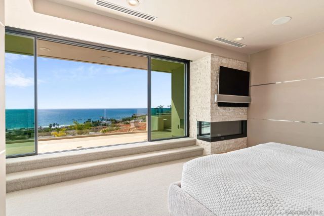 a view of a hallway with furniture and a large window