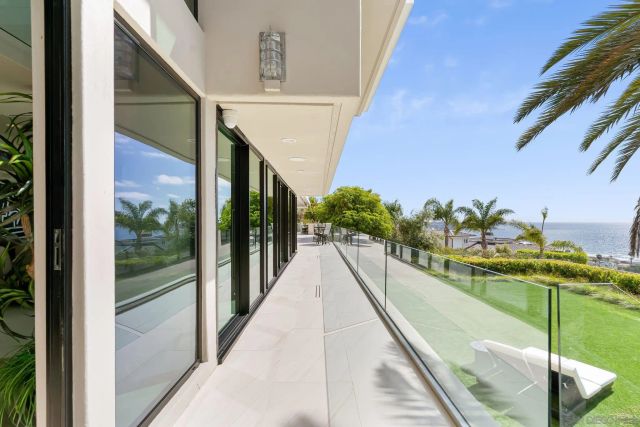 a view of a patio with couches and table and chairs and potted plants